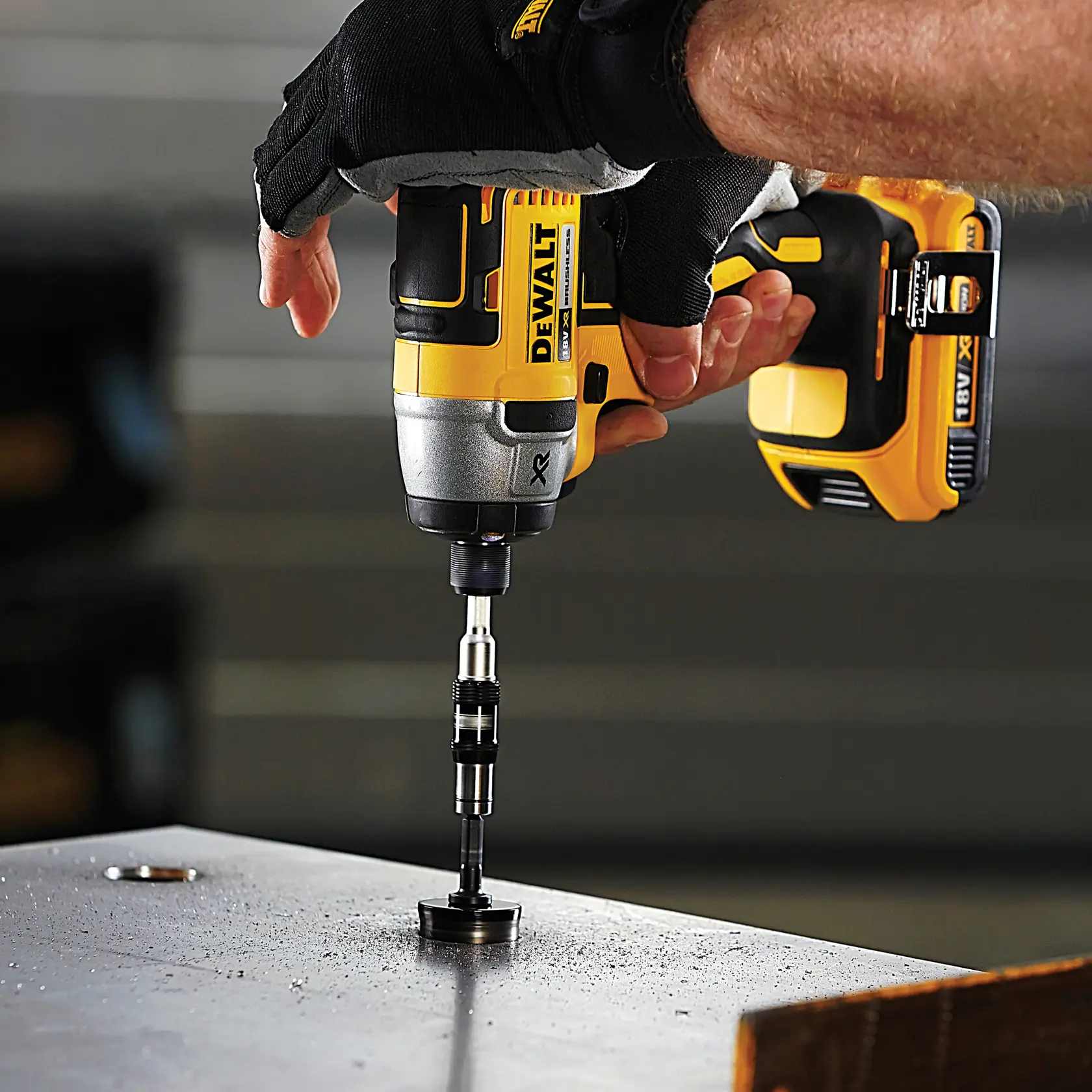 DEWALT drill in use with DT70578T, DT70578T-QZ SKUs, drilling metal surface. Gloved hand operating tool.